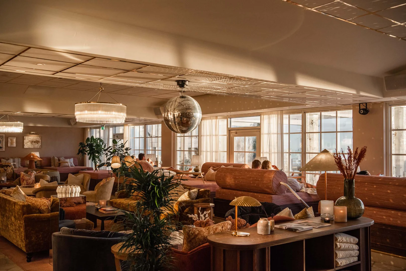 Mysig lounge med havsutsikt på Falkenberg Strandbad där gäster kopplar av i varma jordtoner och naturligt ljus